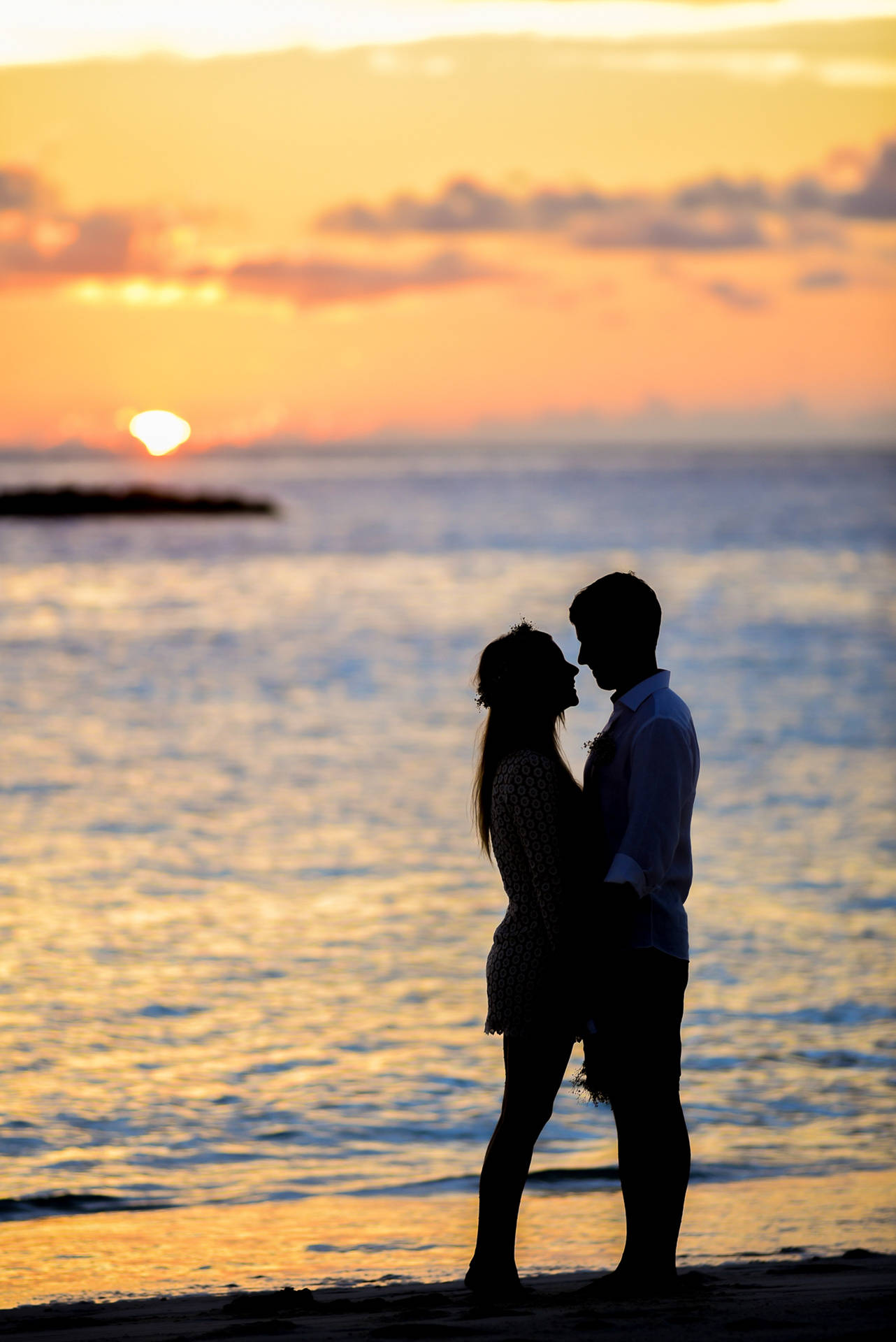 Romantic Beach Couple Chest To Chest At Sunet Background
