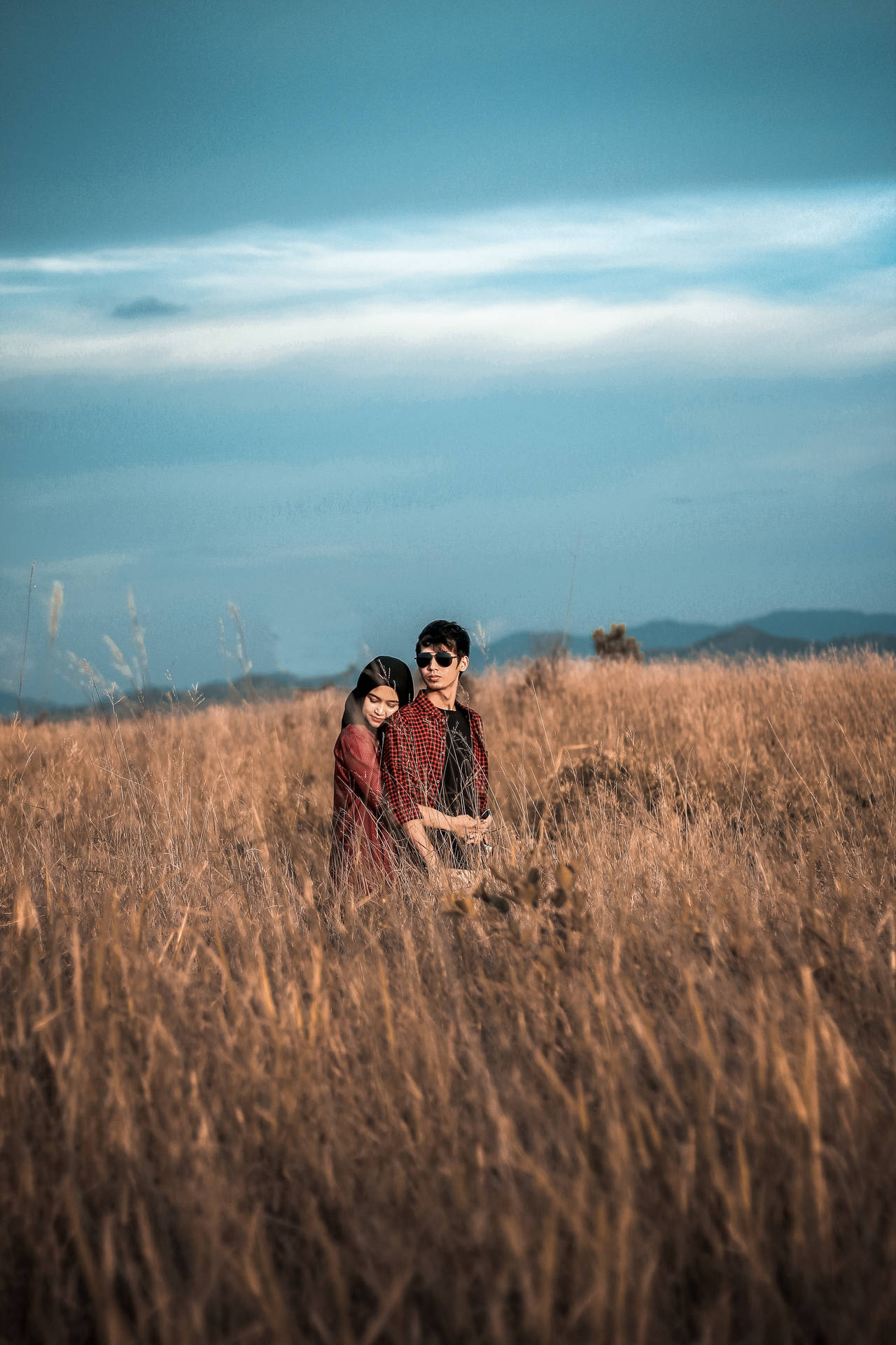Romantic Couple Back Hug On Tall Grass Background