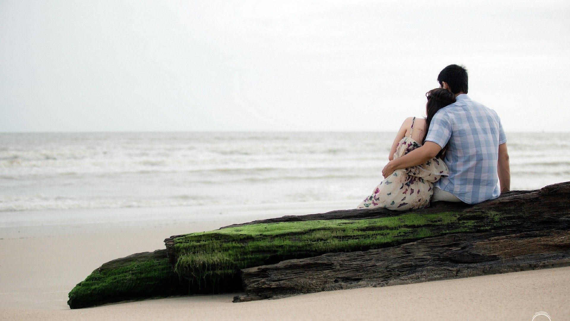 Romantic Couple Enjoying Sunset On Tropical Beach Background