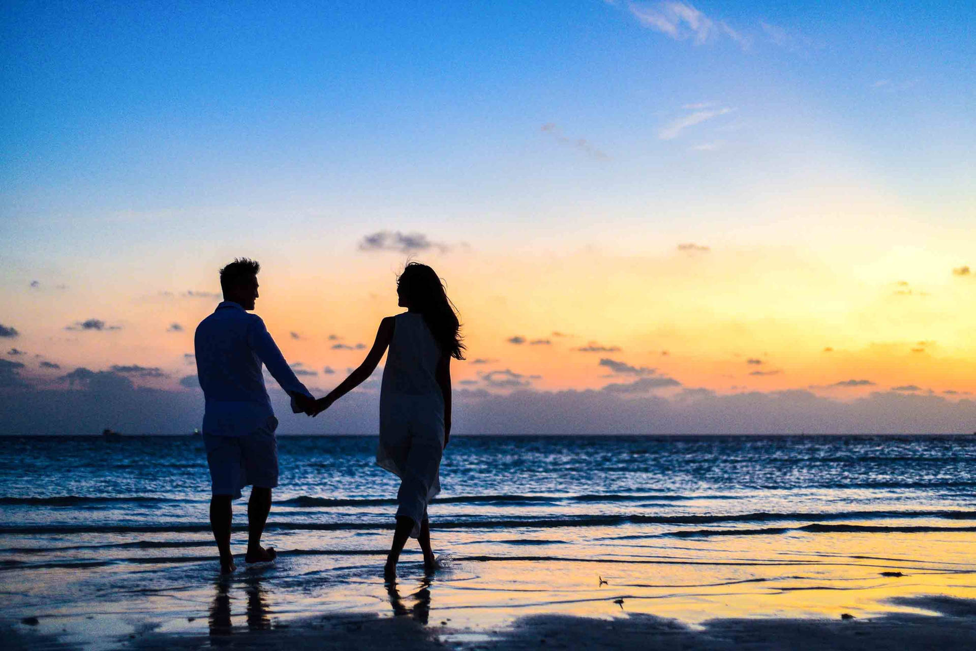Romantic Couple Holding Hands On Seashore