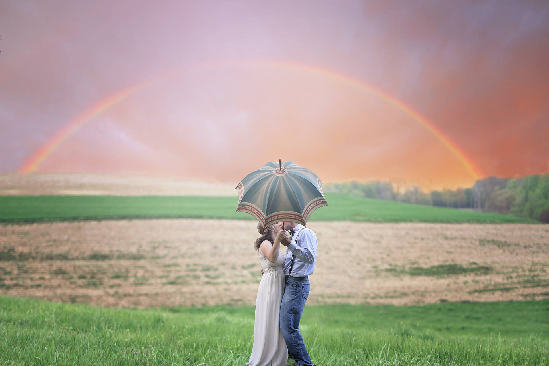 Romantic Couple Kiss Behind Umbrella Under Rainbow