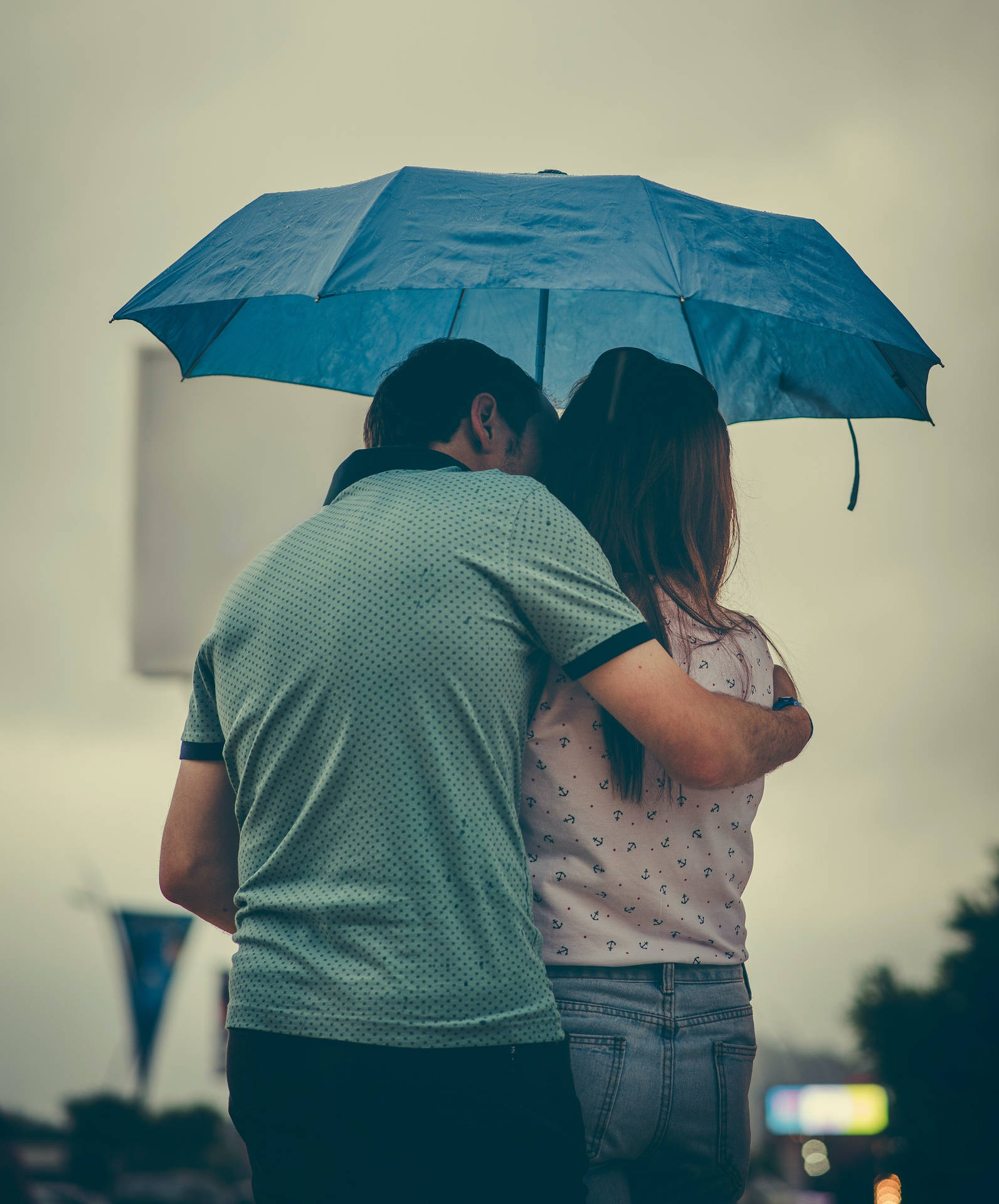 Romantic Couple Kiss Under An Umbrella