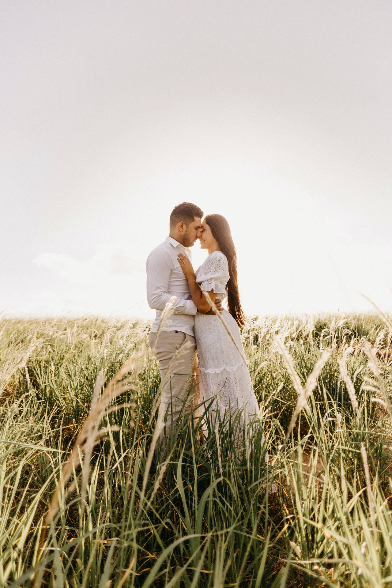 Romantic Couple On Grass Field Background
