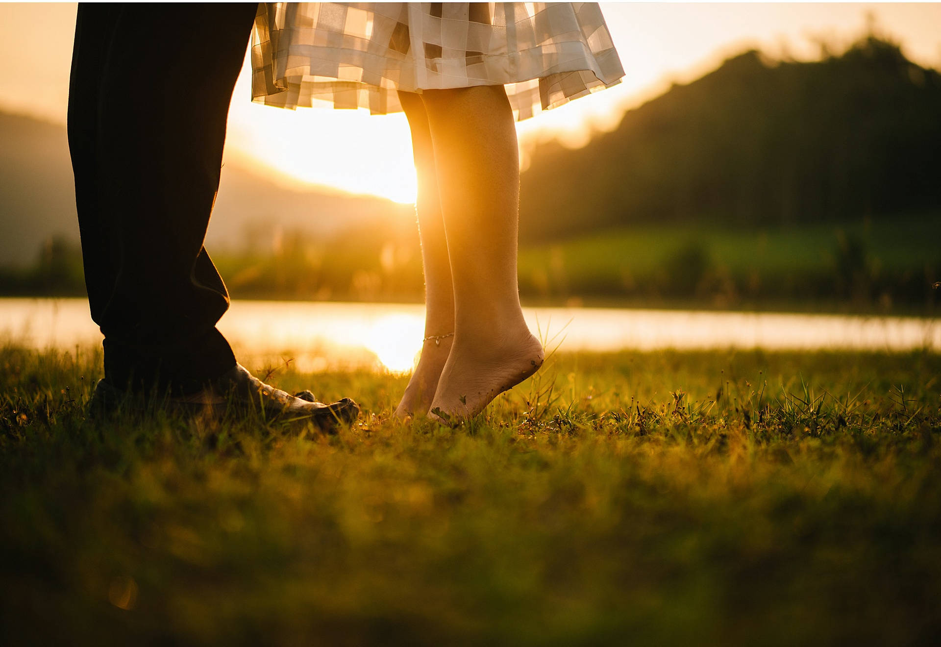 Romantic Couple Tiptoe Kiss On Grass Background