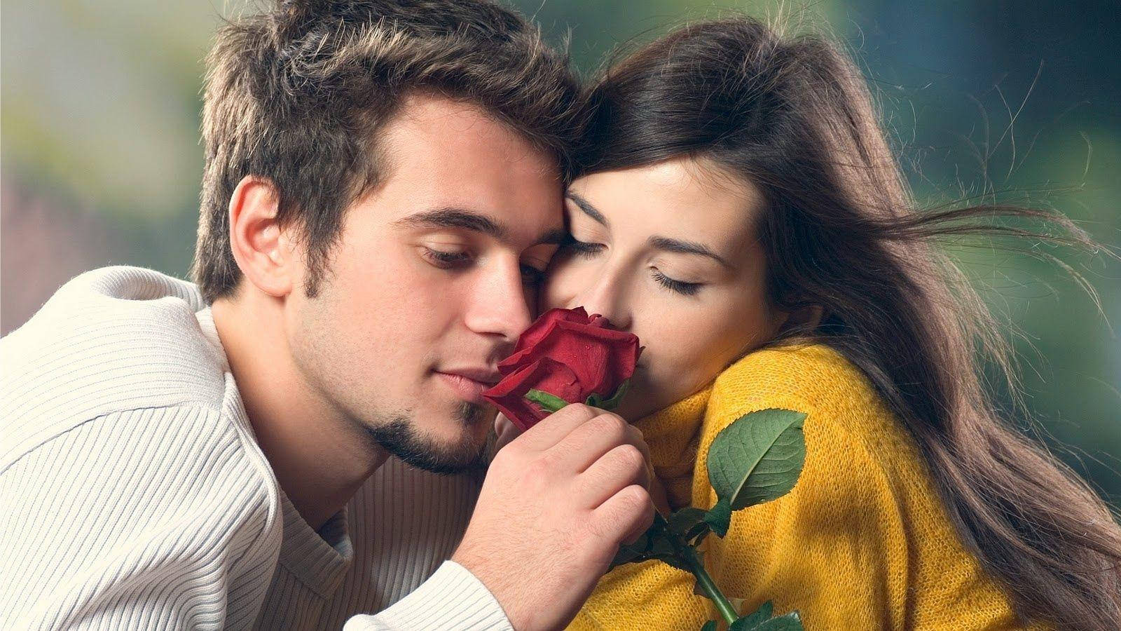 Romantic Couples Smelling A Rose
