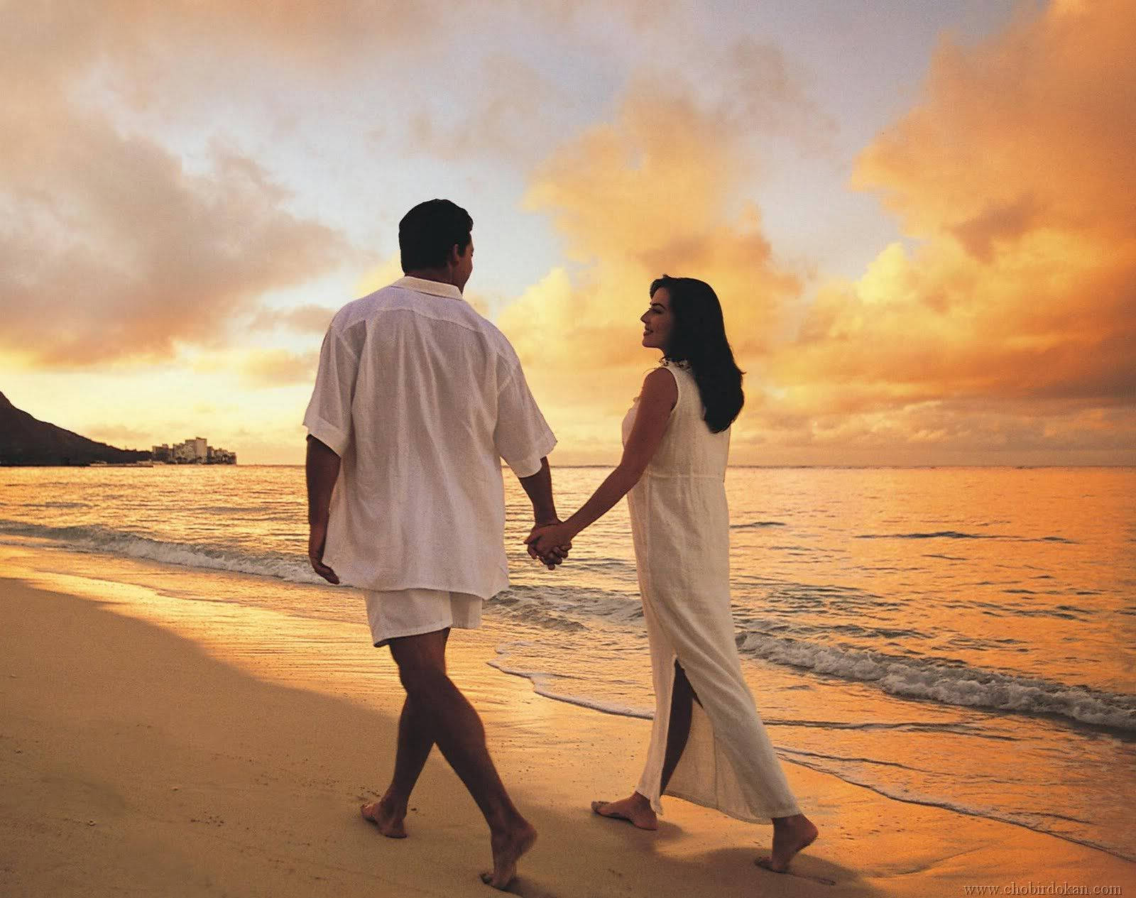 Romantic Escape - Two Lovers Embracing On A Serene Beach Background