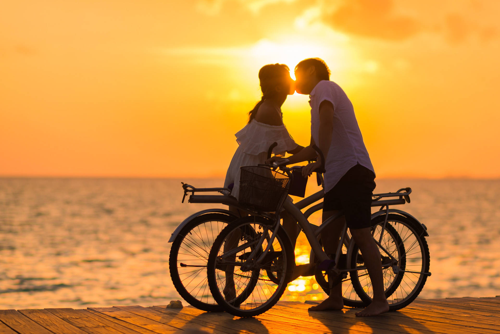 Romantic Love Bicycles Under Sunset Background