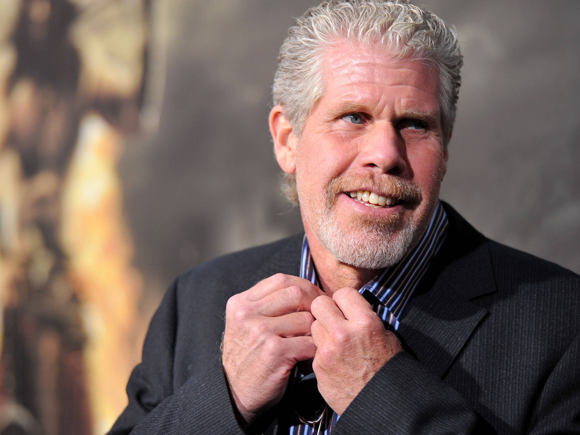 Ron Perlman Fixing His Polo Button