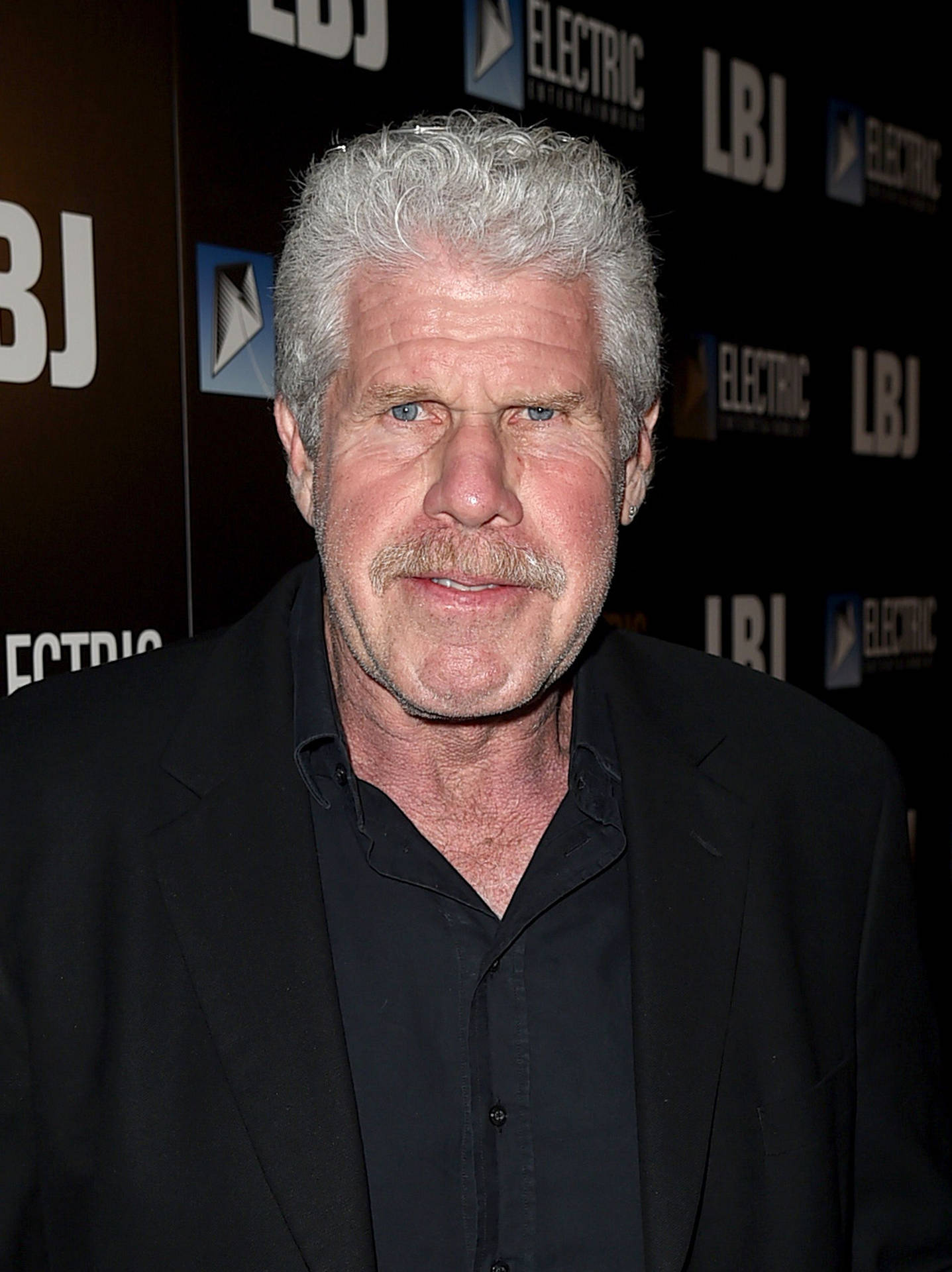 Ron Perlman Sporting Black Outfit Background