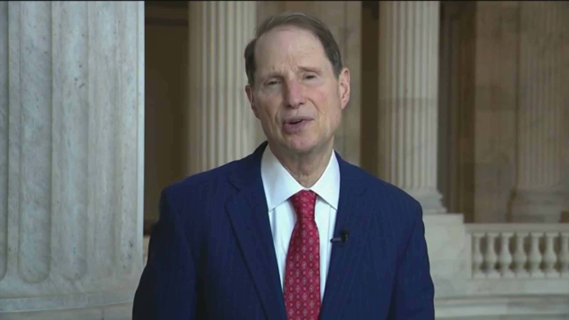 Ron Wyden Blue Suit Red Tie Background