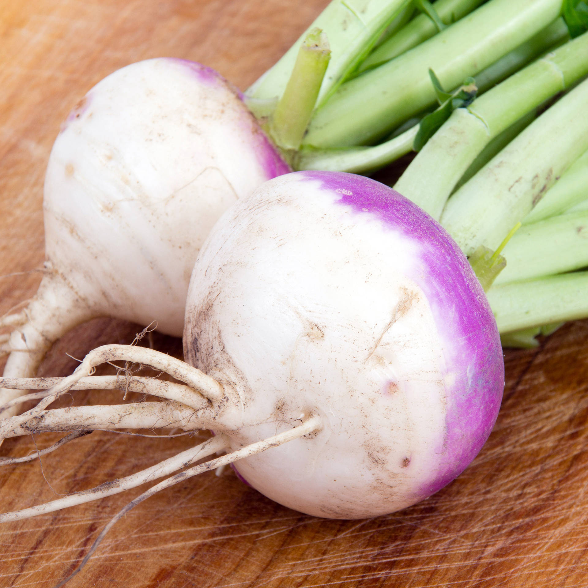 Rooted Turnips On Chopping Board