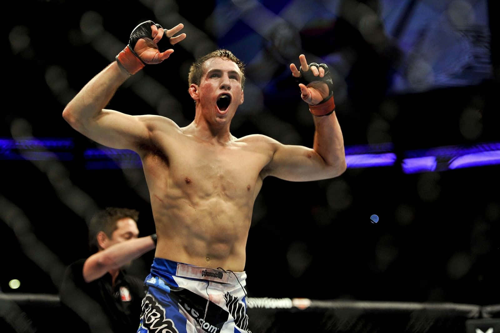 Rory Macdonald Celebrating In The Octagon Background