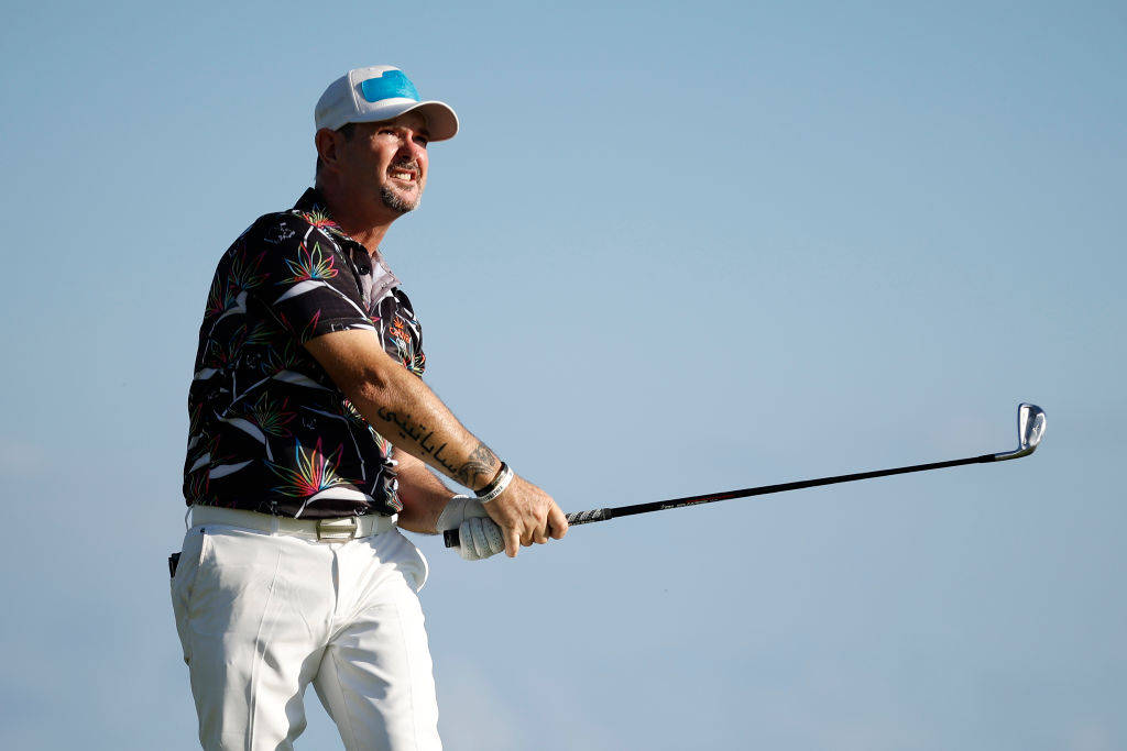 Rory Sabbatini Confidently Holding A Golf Club On The Golf Course Background