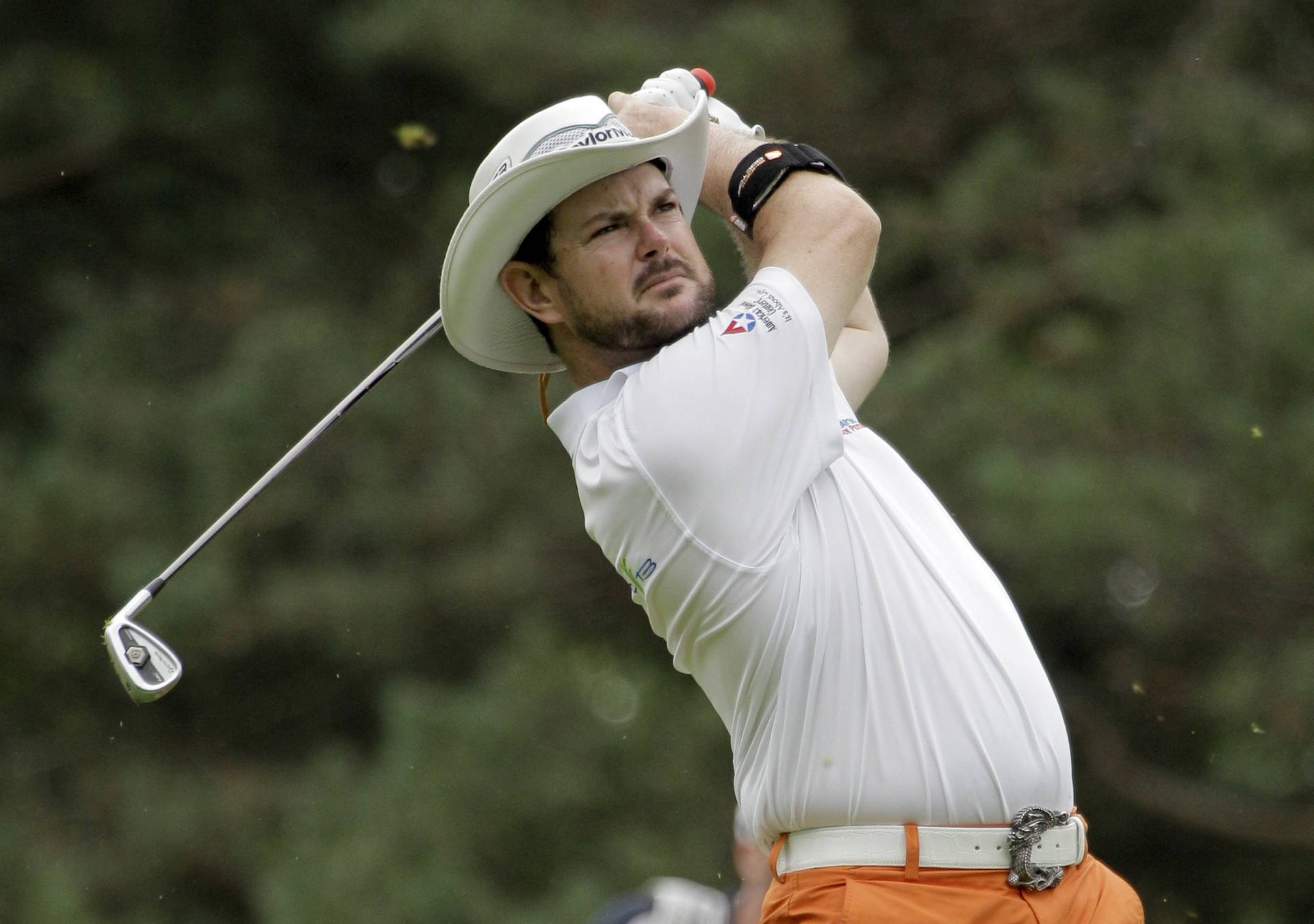 Rory Sabbatini In Mid-swing On The Golf Green Background