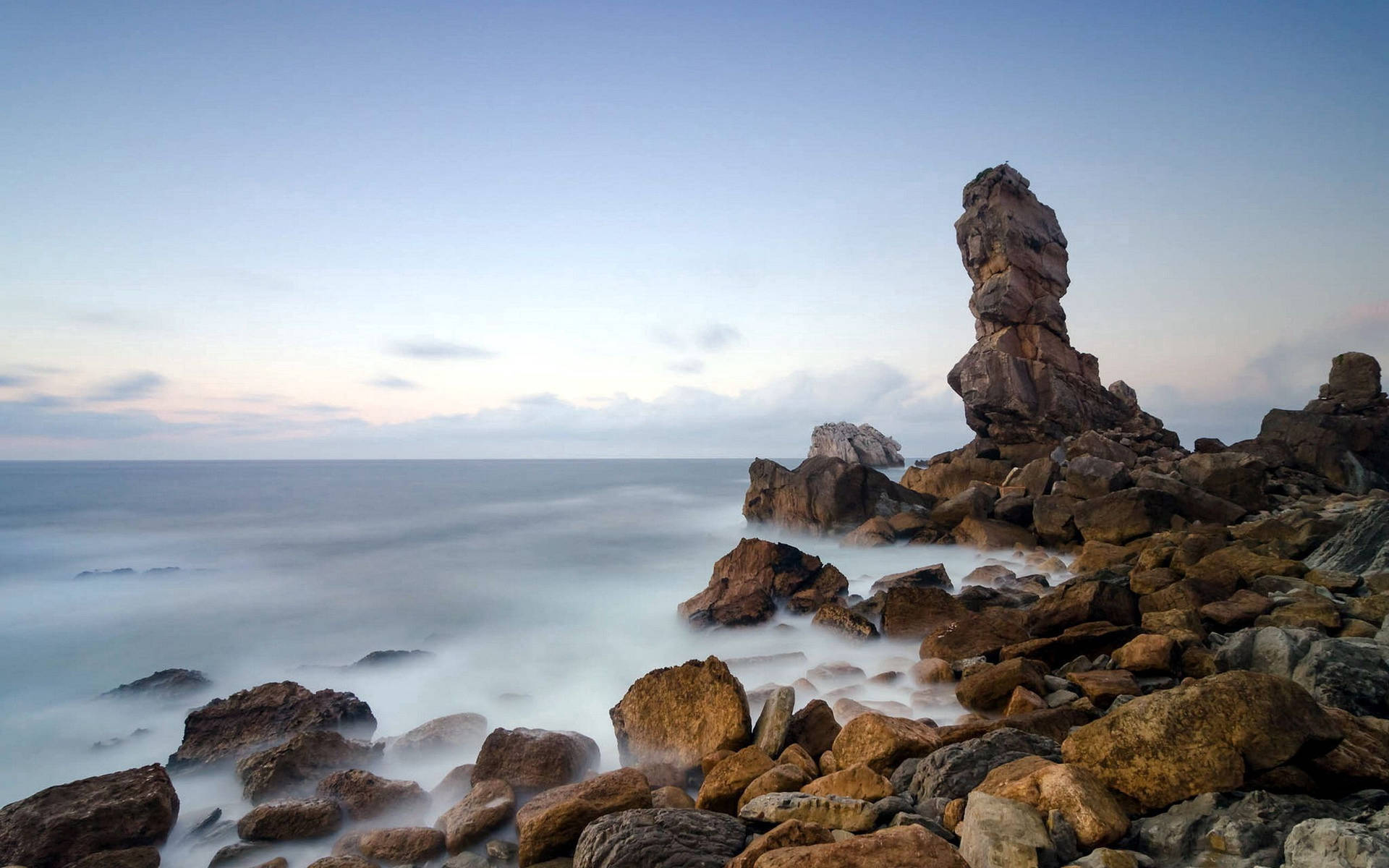 Rough Sea Stone In The Shore Background