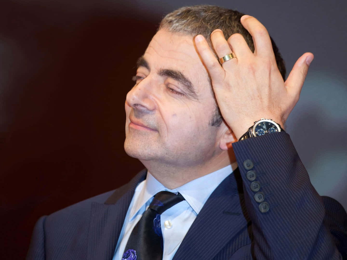 Rowan Atkinson Contemplative Gesture Background