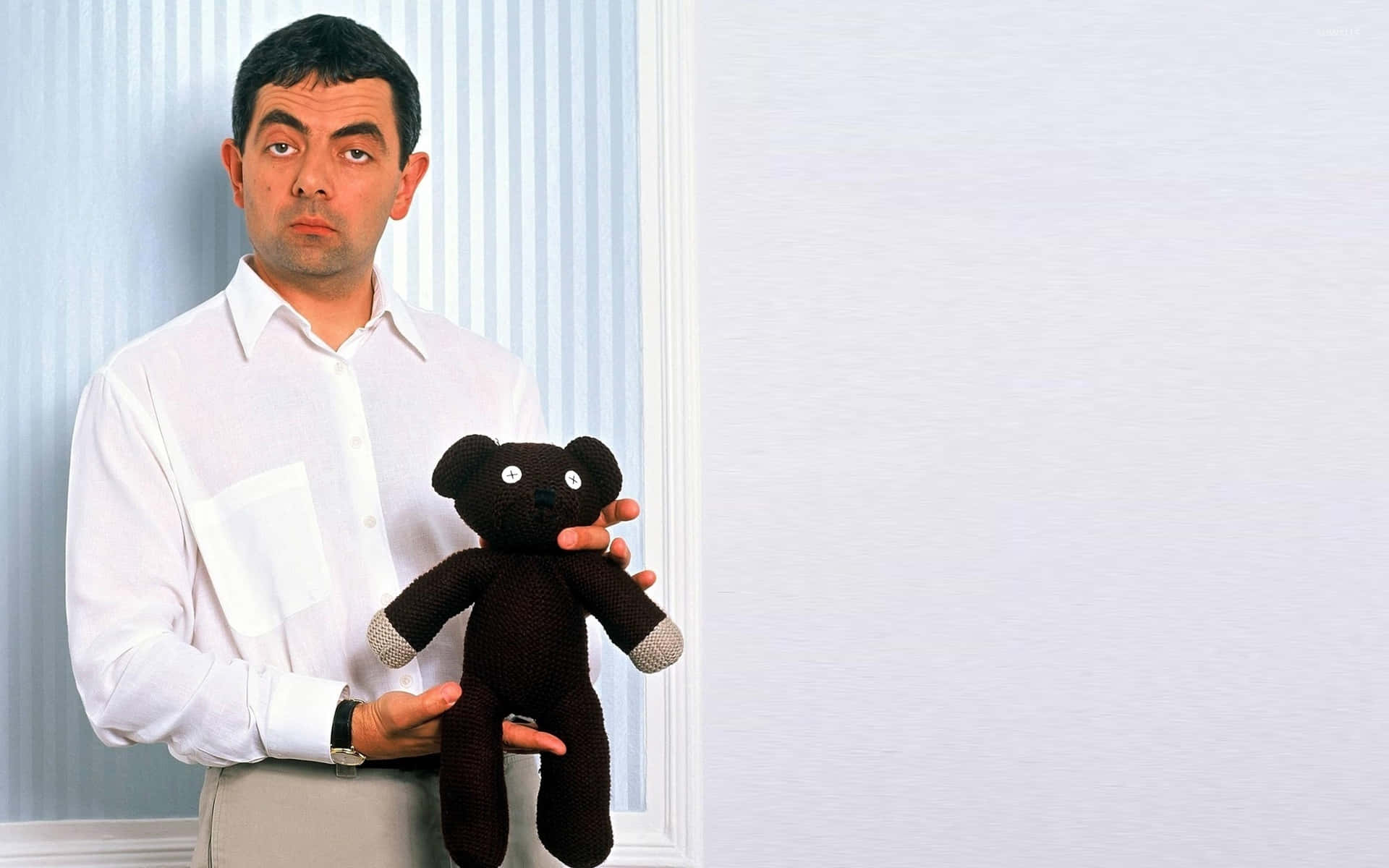 Rowan Atkinson Holding Teddy Background