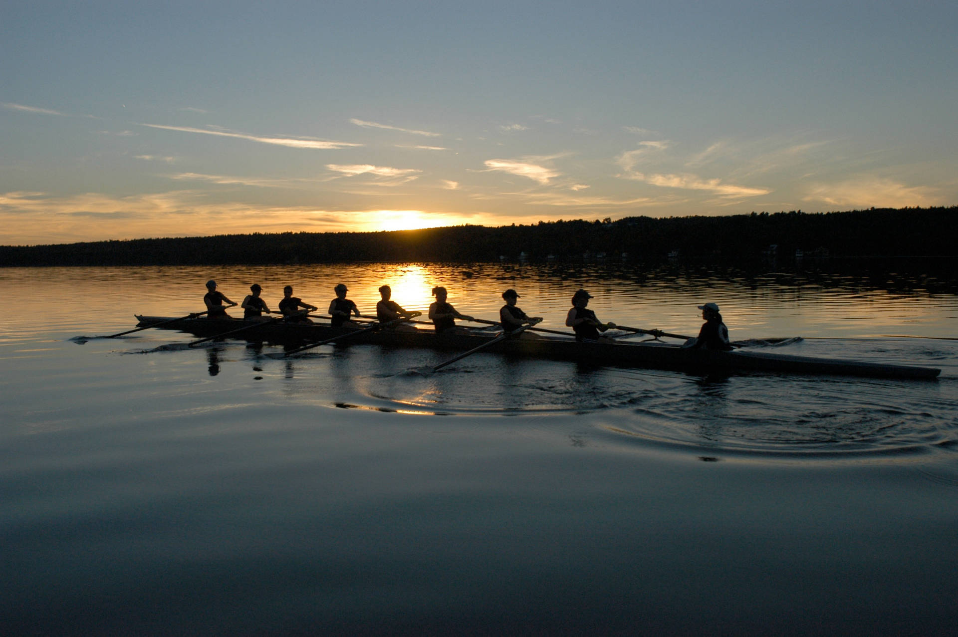Rowing Silhouette In Sunset Background