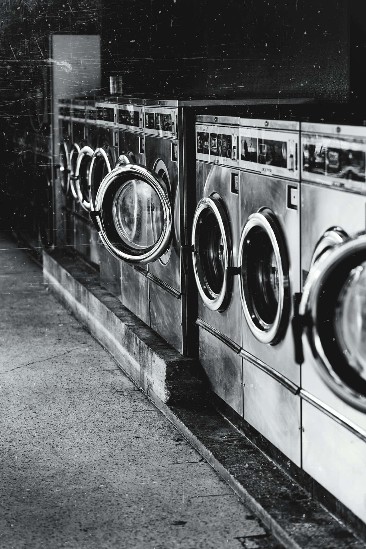 Rowof Washing Machinesin Laundromat Background