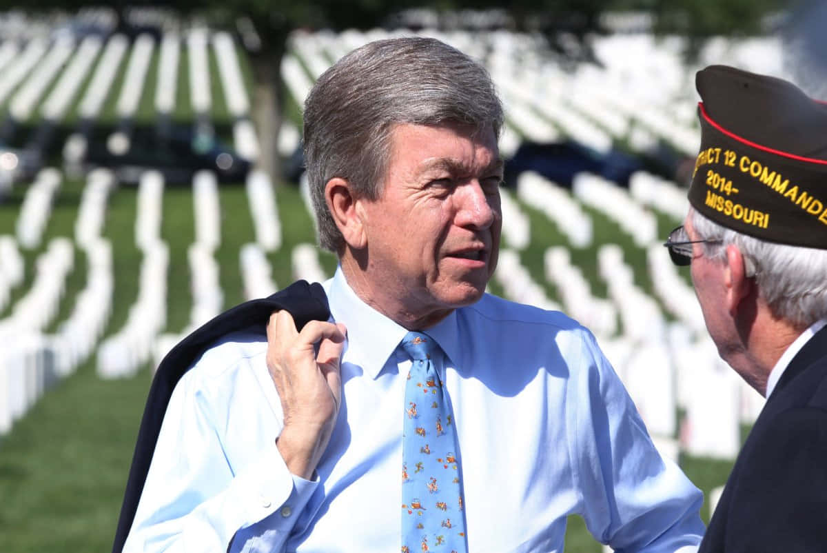 Roy Blunt Visiting A Cemetery Background