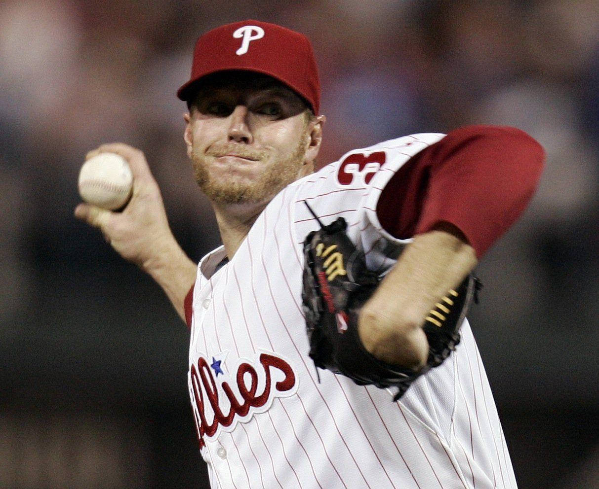 Roy Halladay Focused While Throwing Baseball Background