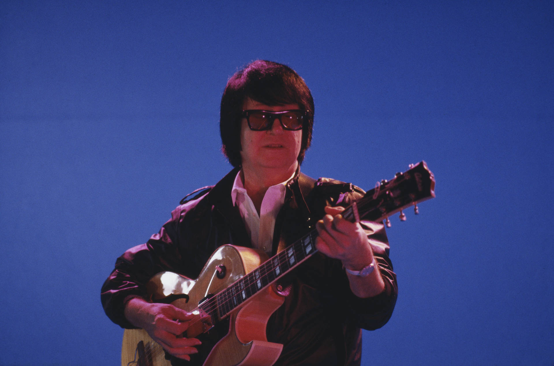 Roy Orbison Live Performance Blue Background Background