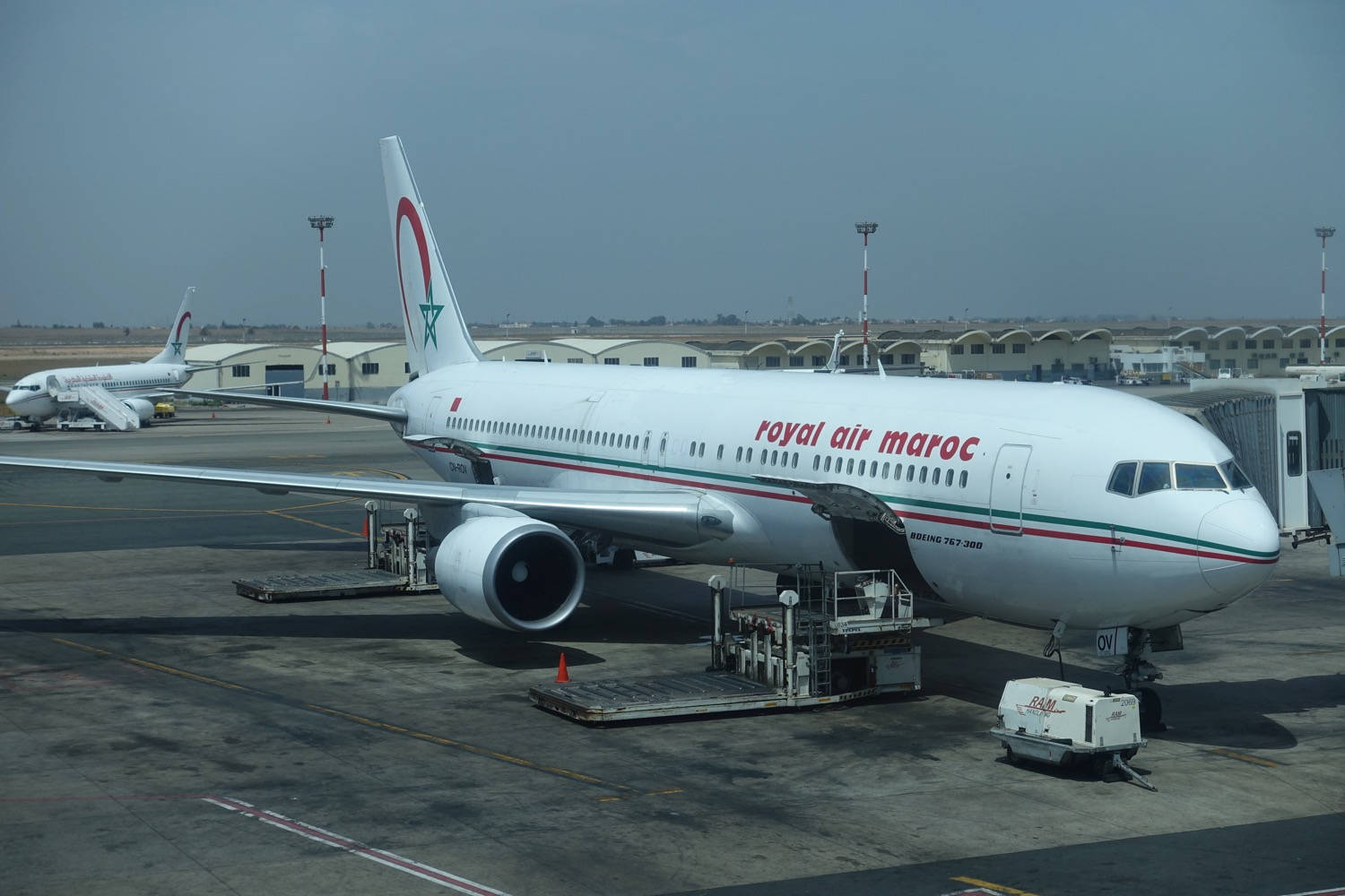 Royal Air Maroc Airplane With Cargo Vehicle Background