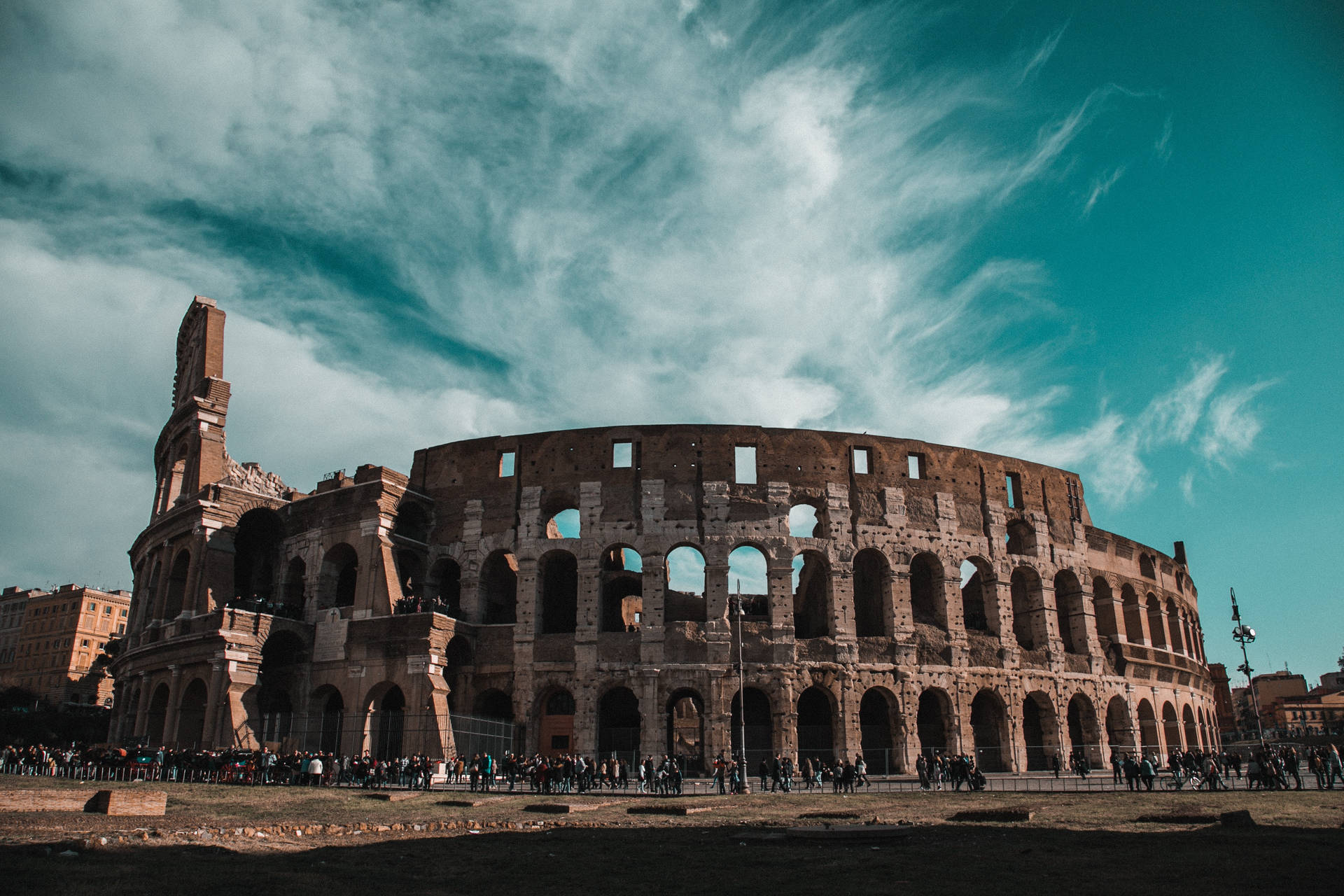 Ruins Of The Colosseum Beneath Dark Blue Sky Background