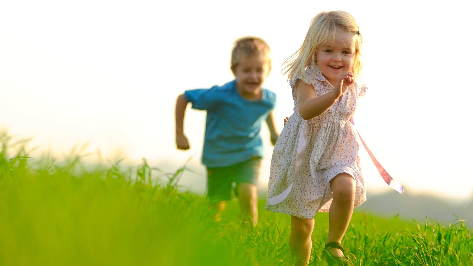 Running Children On A Grass Field Background