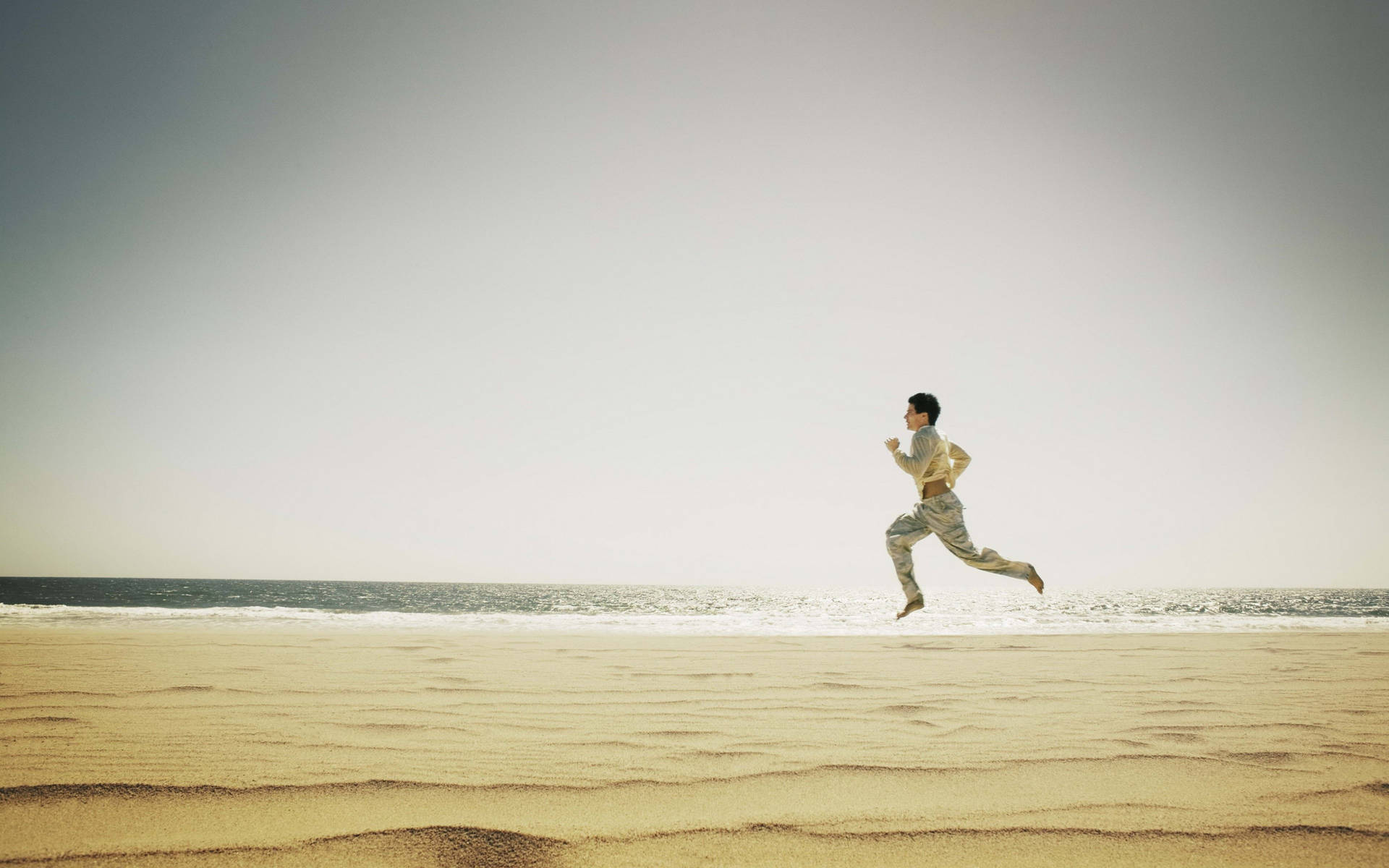 Running Man In Beach Shore Background