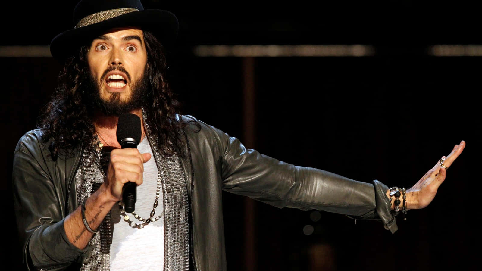 Russell Brand Comedian On Stage Background