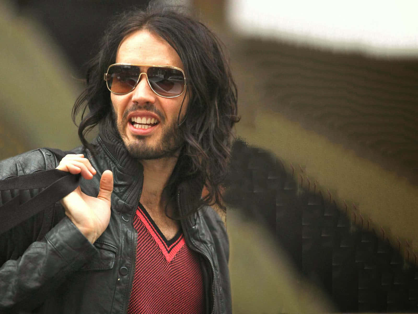 Russell Brand Contemplating Happily Background