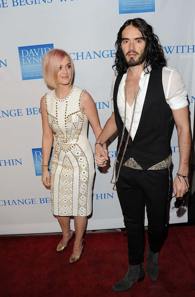 Russell Brand With Katy Perry On Red Carpet Background