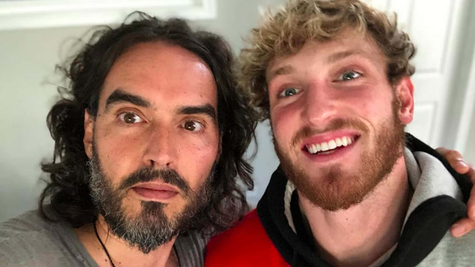 Russell Brand With Logan Paul Background