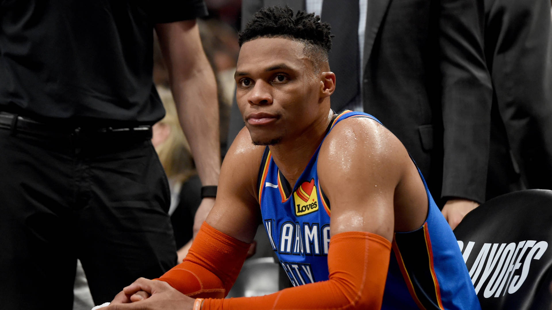 Russell Westbrook Sitting On Bench Background