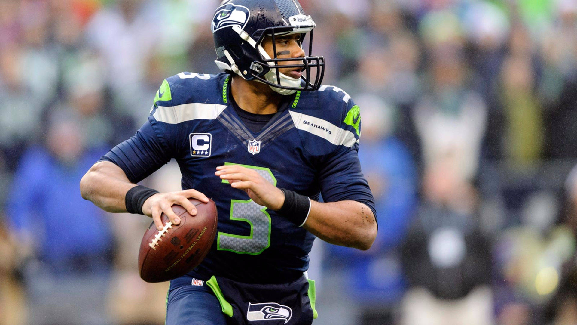 Russell Wilson Holding Football Background