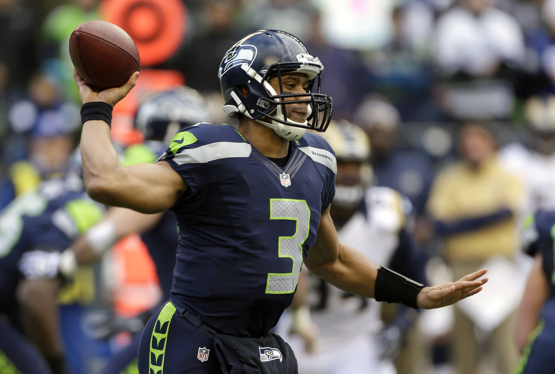 Russell Wilson Holding Football Up Background