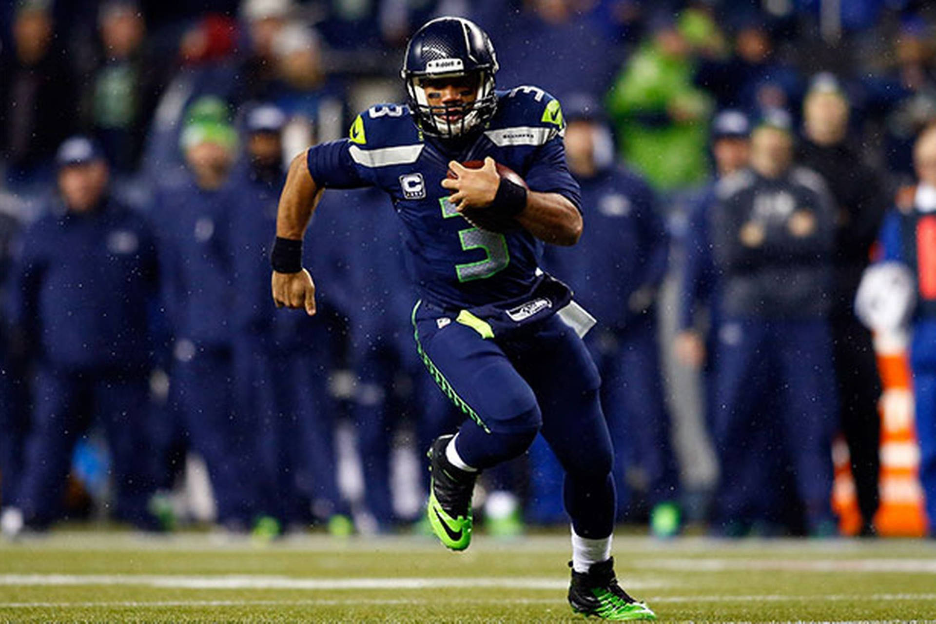 Russell Wilson Running In The Rain Background