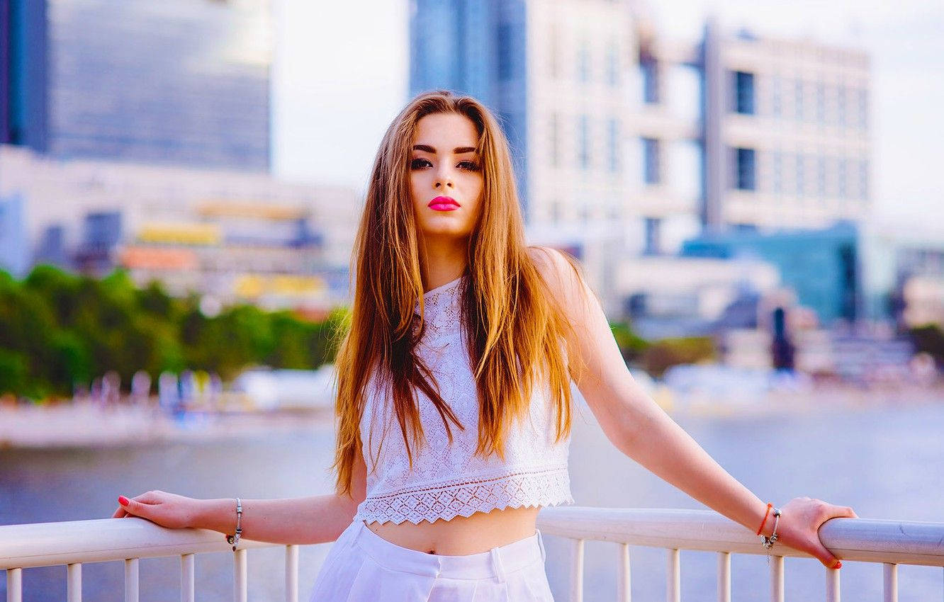 Russian Girl Posing Against Railing Background