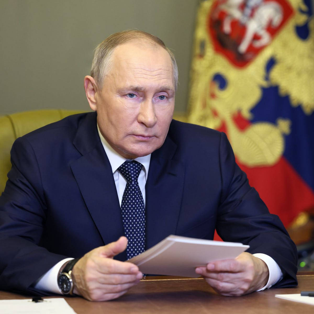 Russian President Vladimir Putin Holding Important Documents Background