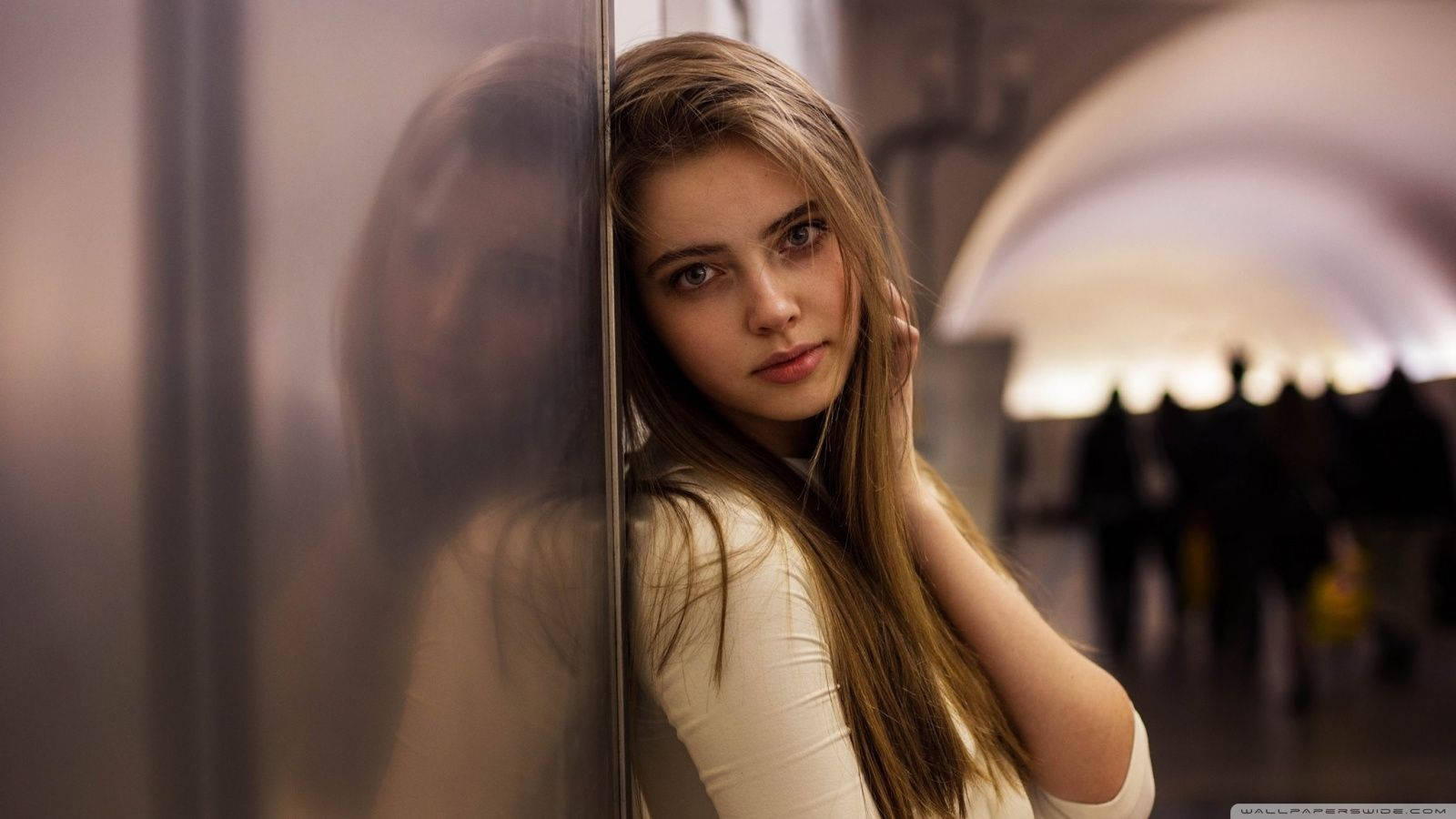 Russian Schoolgirl Learning While Leaning Against A Steel Wall Background