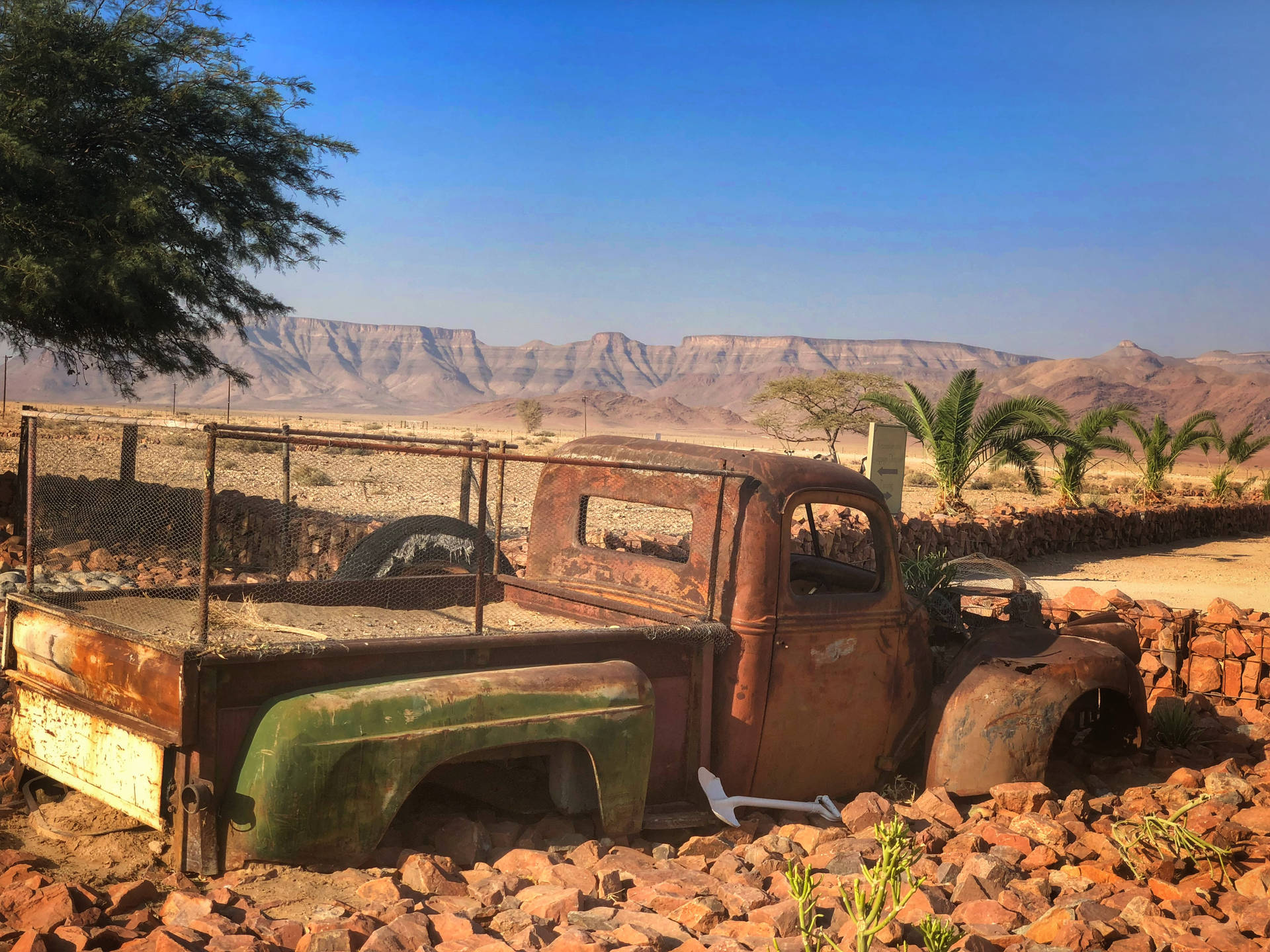 Rusty Truck In The Desert In Namibia Background