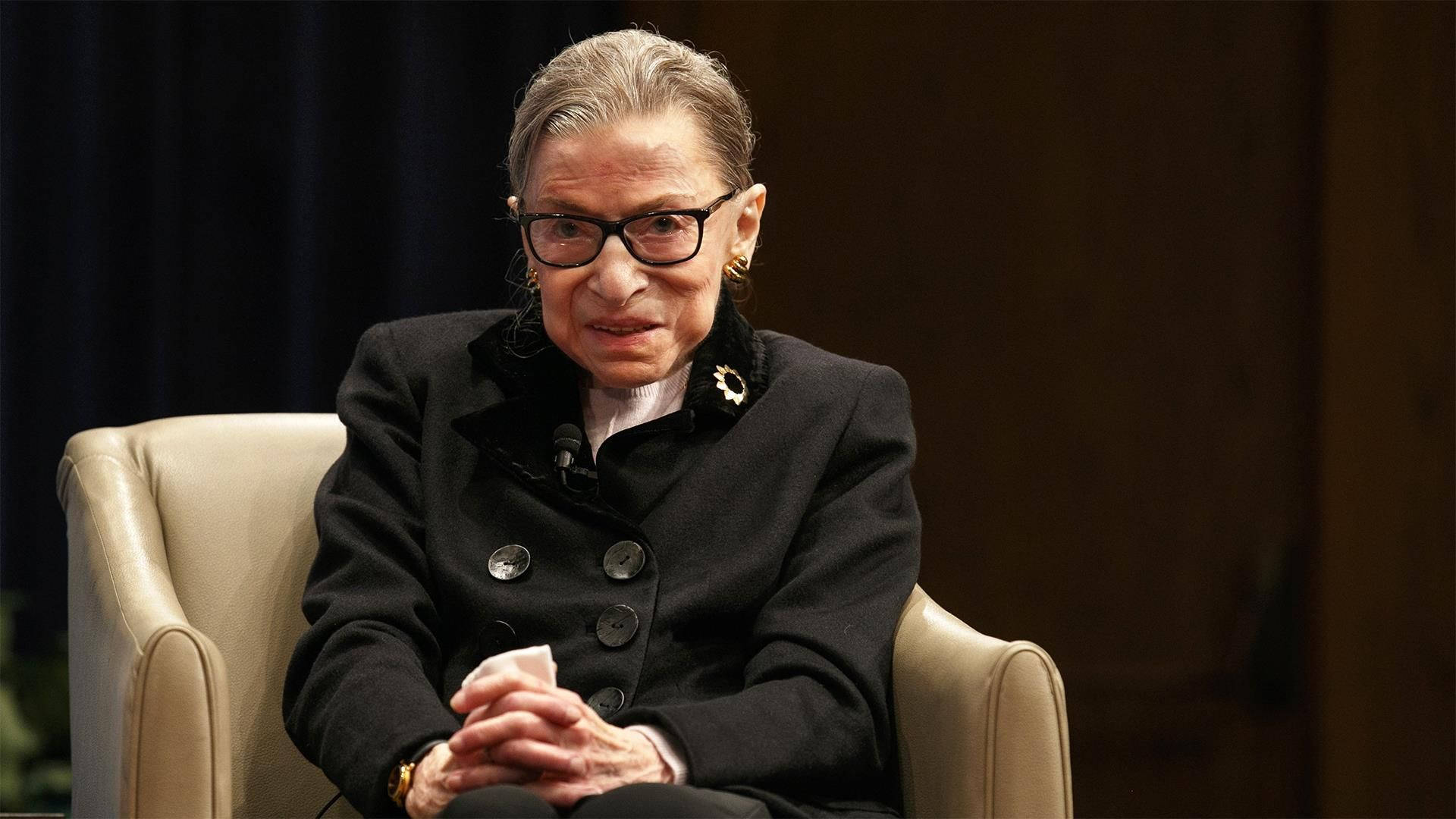 Ruth Bader Ginsburg Seated On Couch