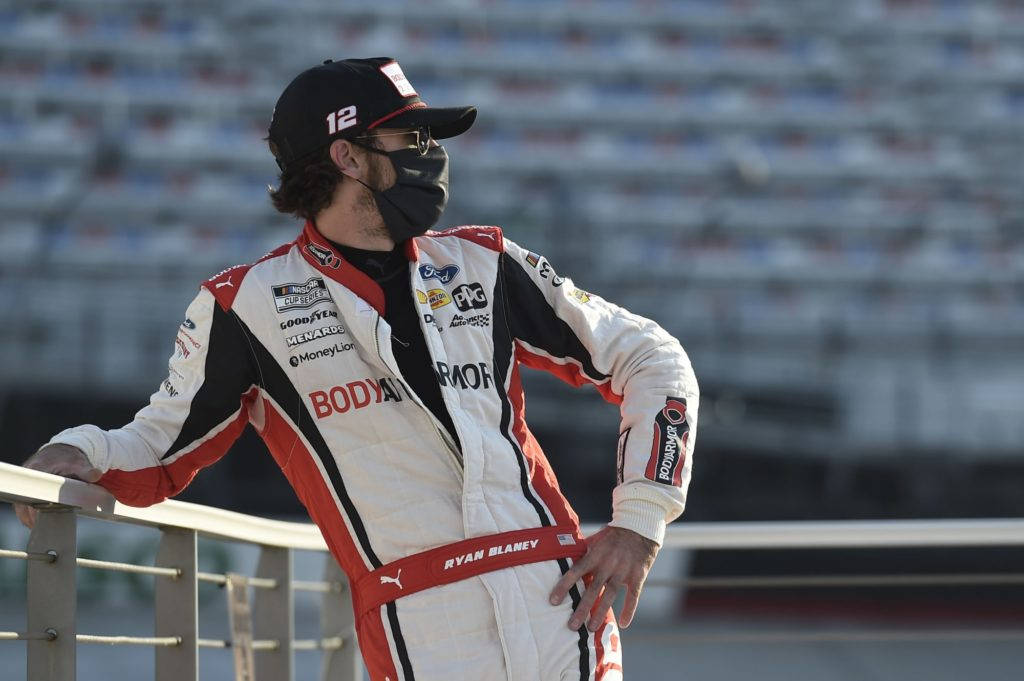 Ryan Blaney Leaning On Metal Railway Background