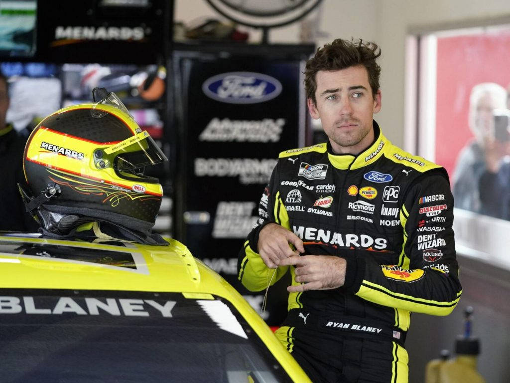 Ryan Blaney Standing Beside Race Car Background