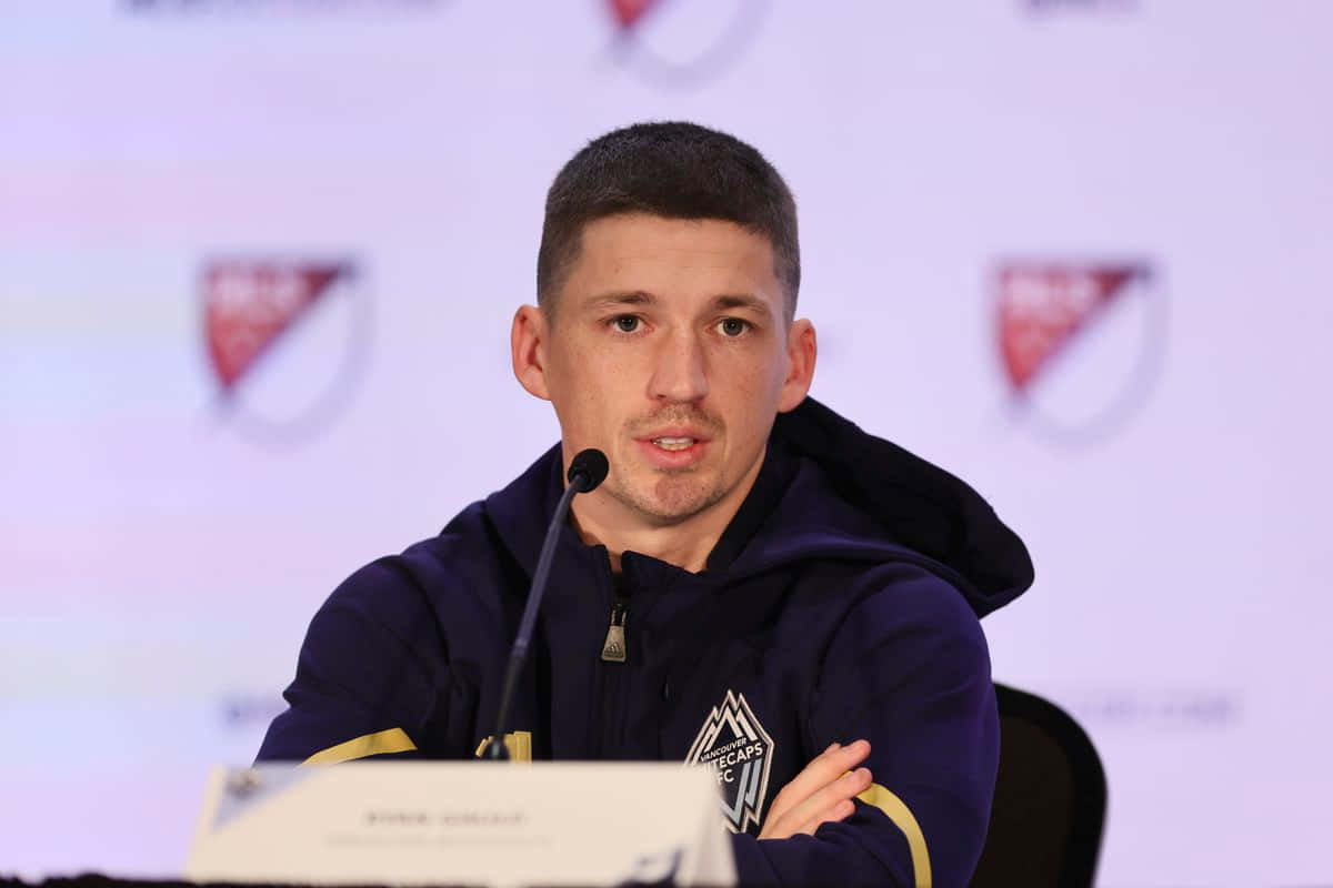 Ryan Gauld Speakingat Press Conference Background