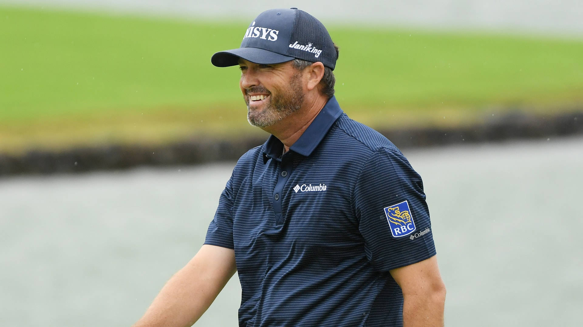 Ryan Palmer Blue Shirt Cap Smiling Background