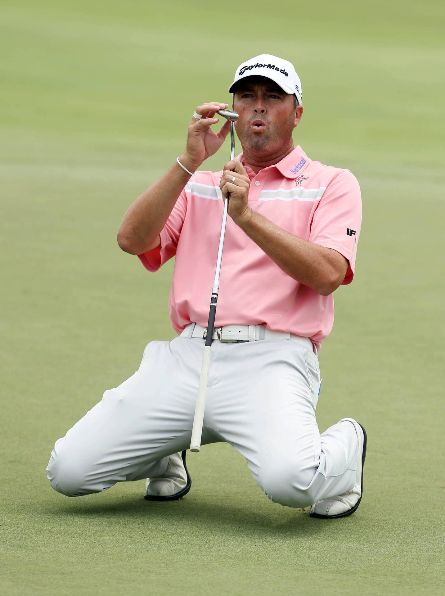 Ryan Palmer Pink Shirt Kneeling On Field Background