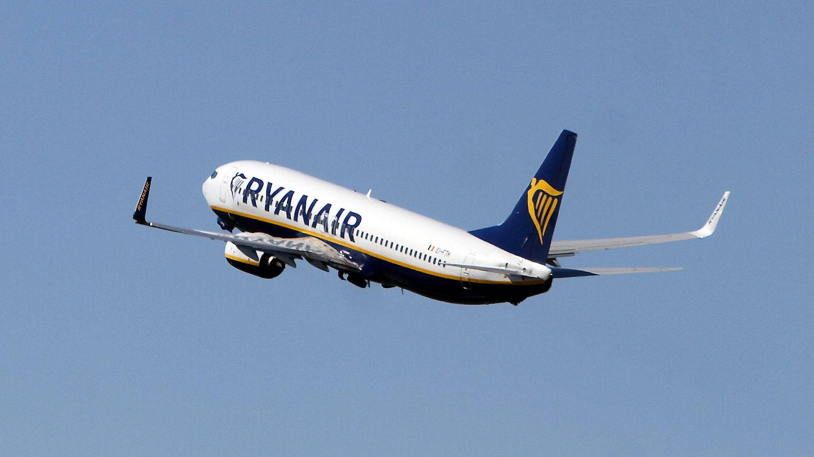 Ryanair Aircraft Soaring Through The Sky Background