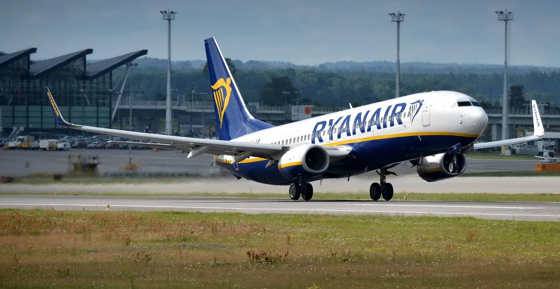 Ryanair Airplane On Runway With Grass Background